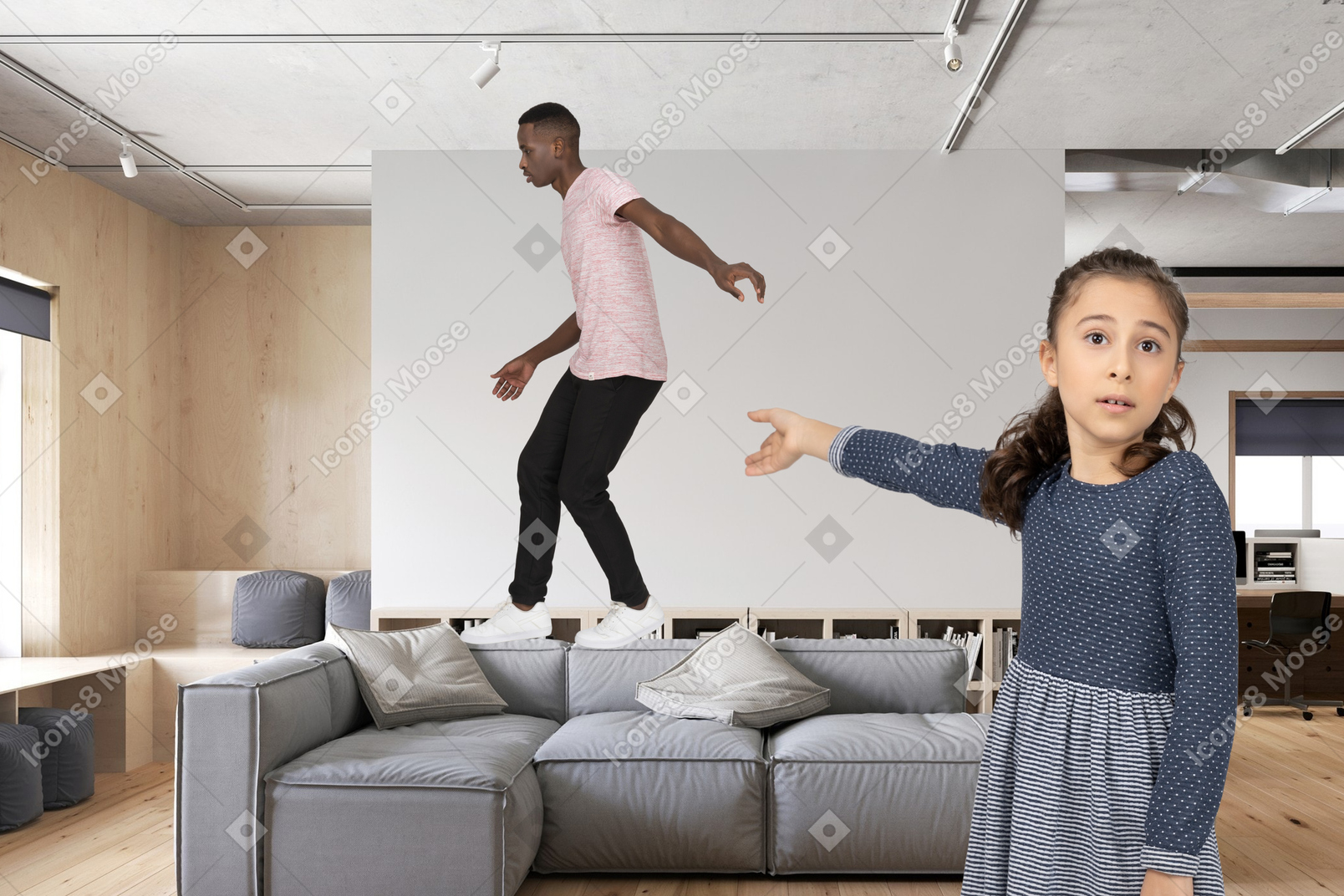 A girl pointing at a man walking on a sofa