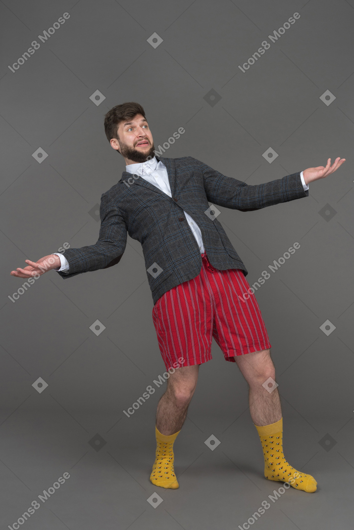 Expressive businessman spreading arms wide apart