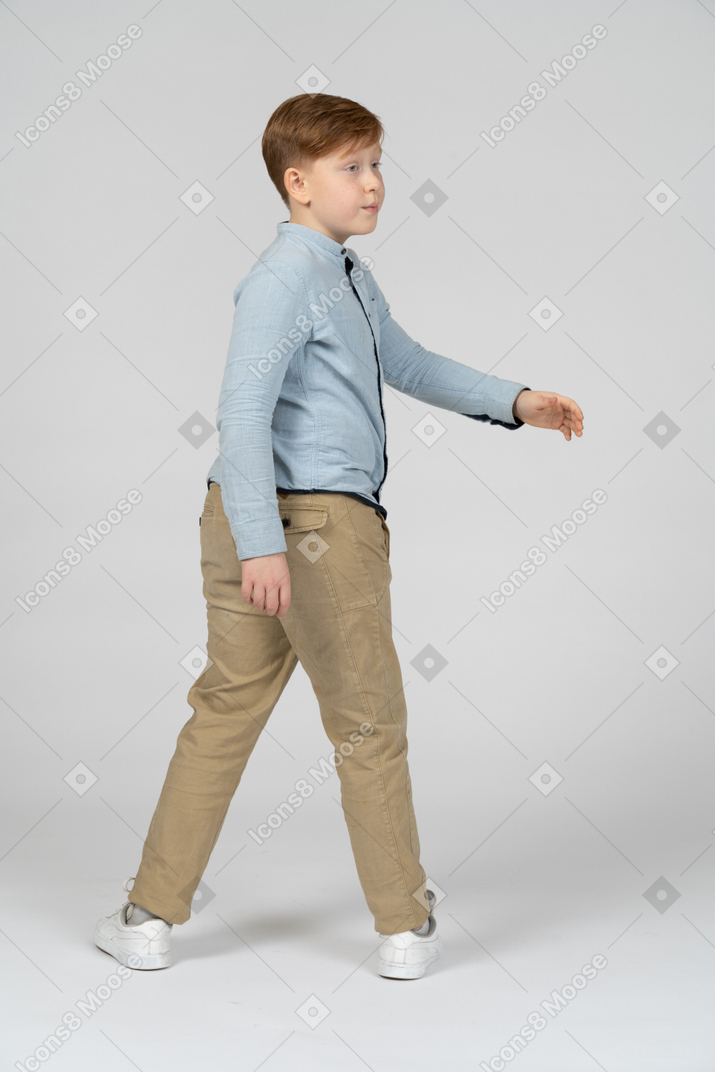 Boy turning to walk to the right