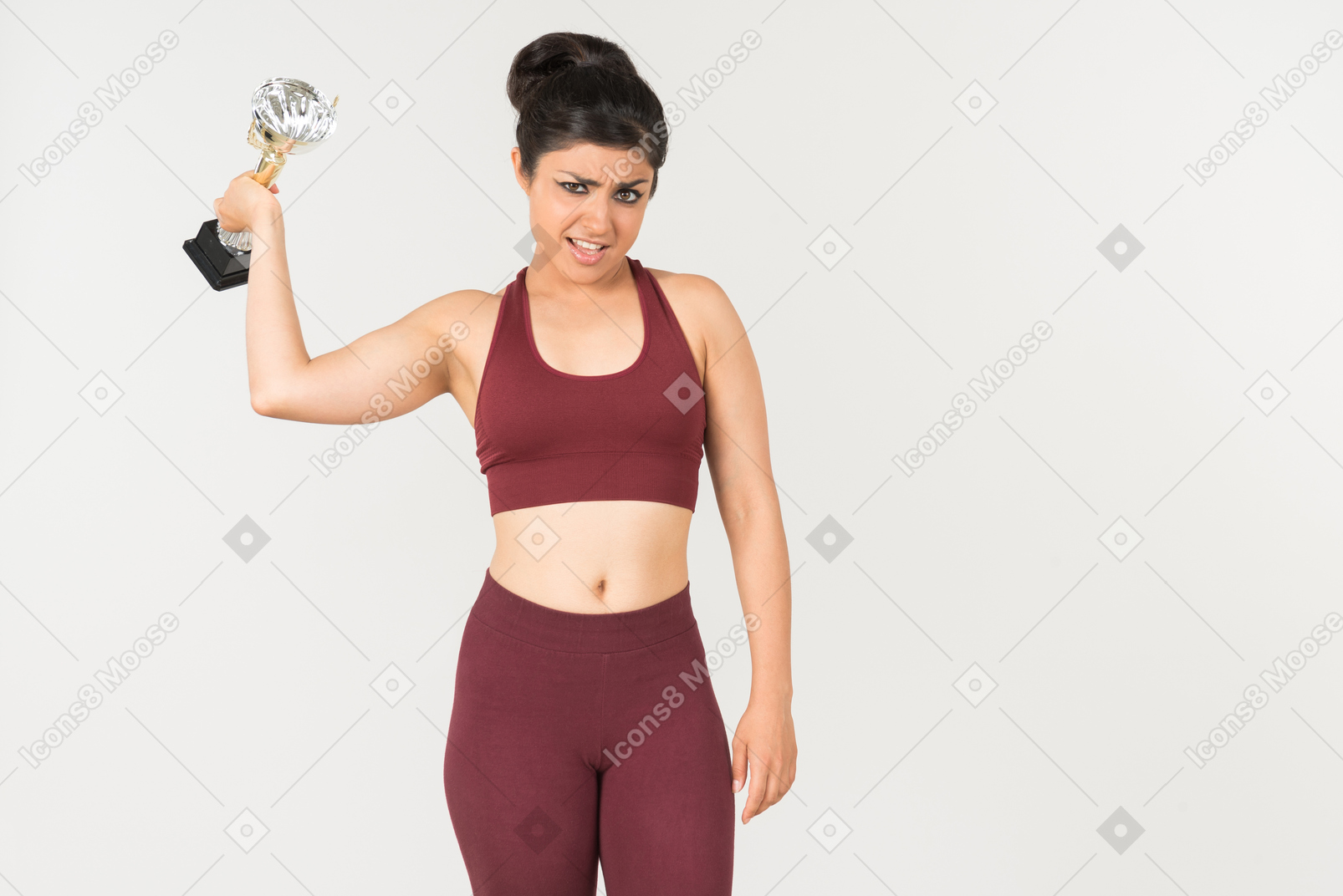Angry looking young indian woman holding award