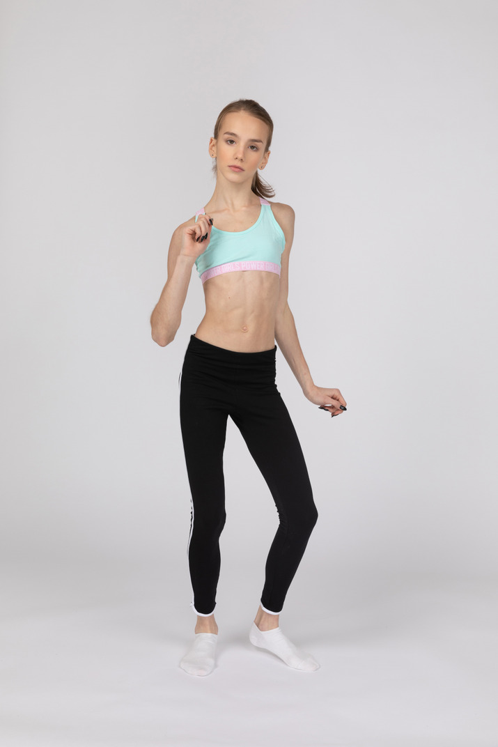 Full-length of a teen girl in sportswear gesticulating and dancing