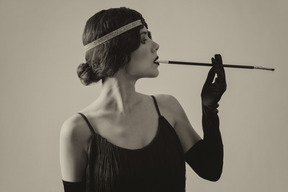 Black and white portrait of a flapper smoking cigarette