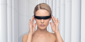 Beautiful android adjusting eyewear against a  futuristic colonnade of white columns