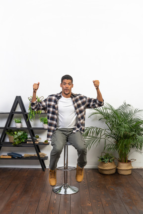 Good looking young man sitting on a chair