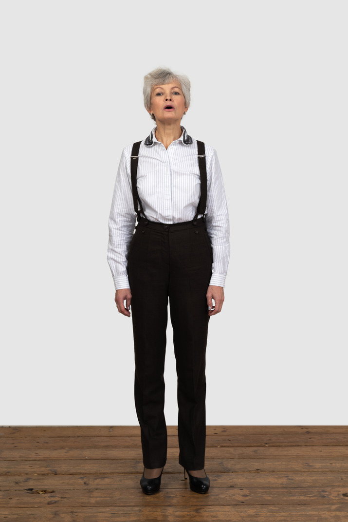Front view of an old female in office clothes talking