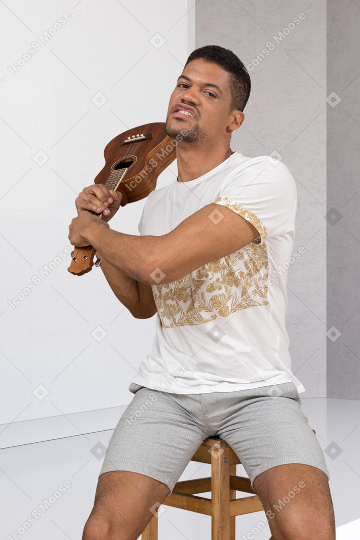 Person poses with a guitar
