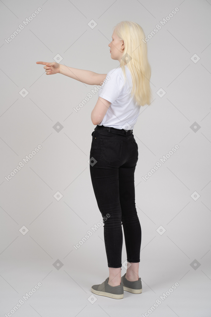 Back view of a young woman pointing