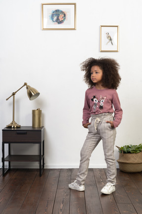 Cute girl kid posing on the apartments background