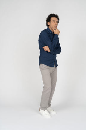 Side view of a man in casual clothes thinking