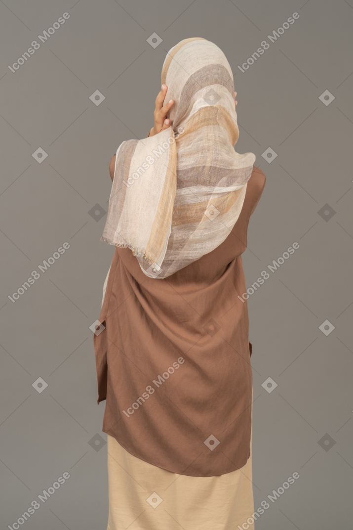 Woman in traditional clothes with her hands on her face