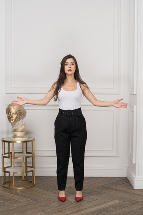 Front view of young businesswoman raising hands