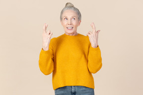 Elegant older woman in a mustard sweater