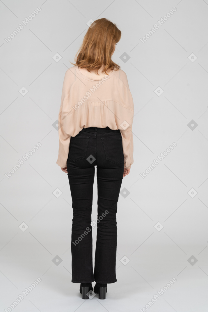 Back view of young woman looking aside