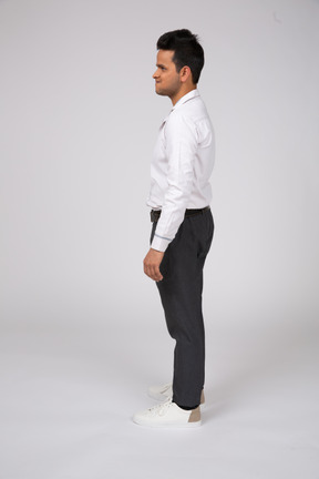 Side view of a man in a white shirt and black pants