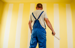 Worker painting a wall