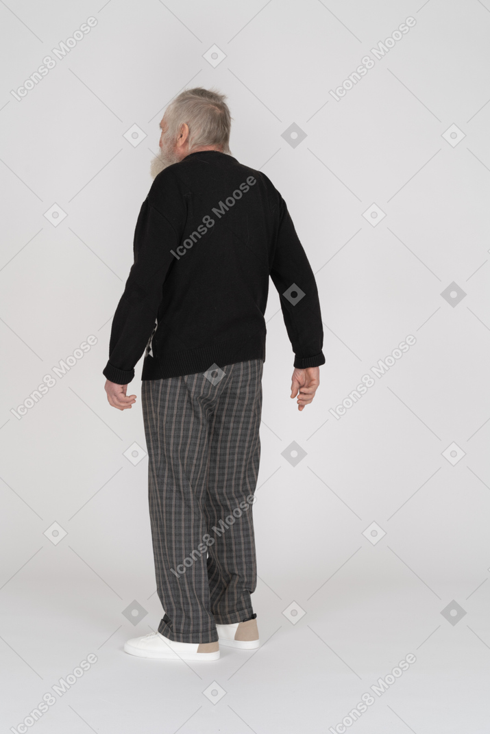 Elderly man standing with his back toward the camera