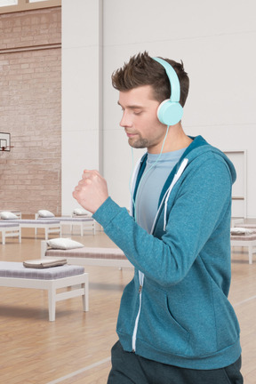 A man wearing headphones in a hospital