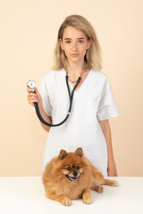 Attractive veterenarian ready to examine a spitz