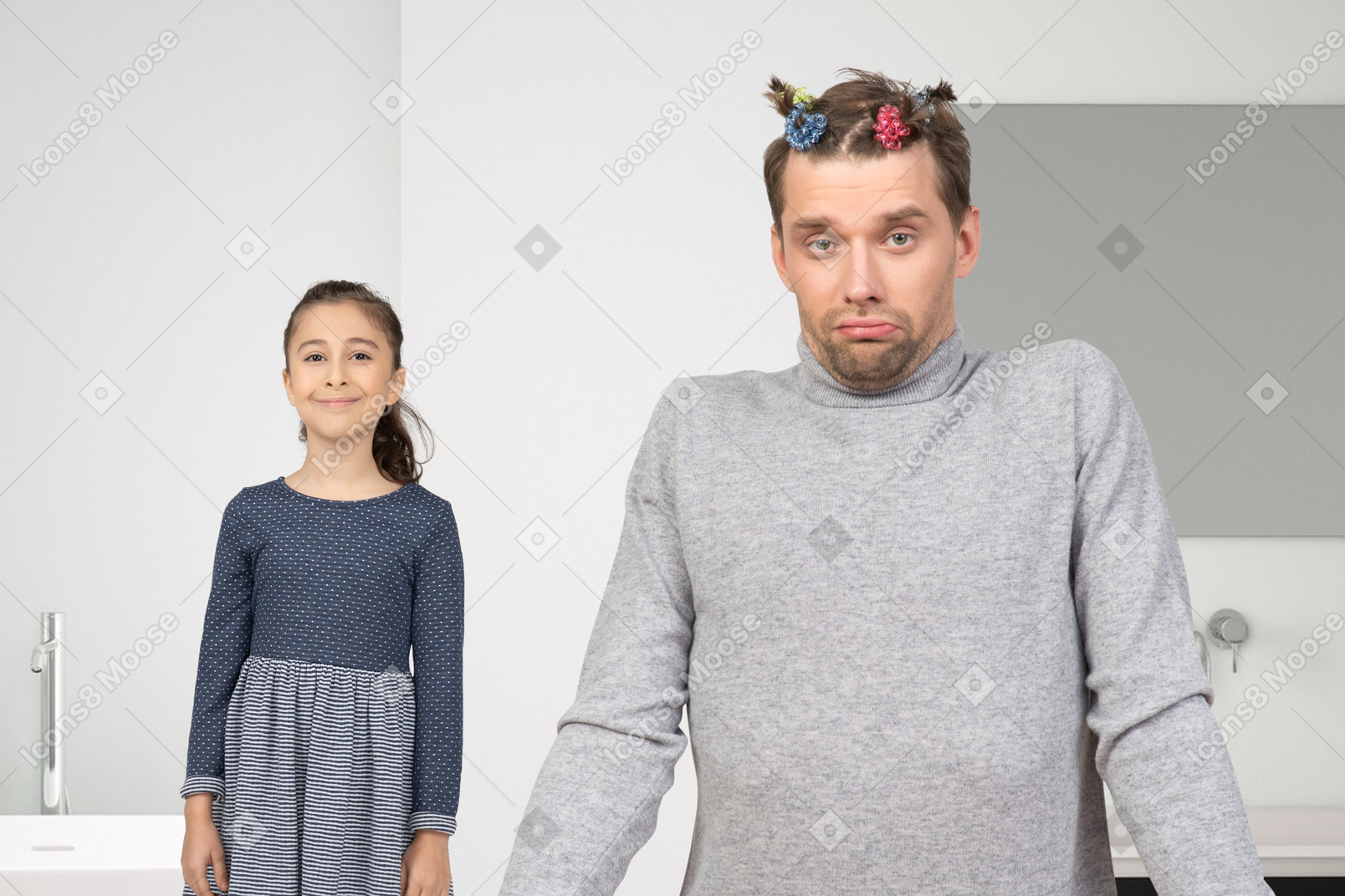 A man with scrunchies in hair standng next to a little girl