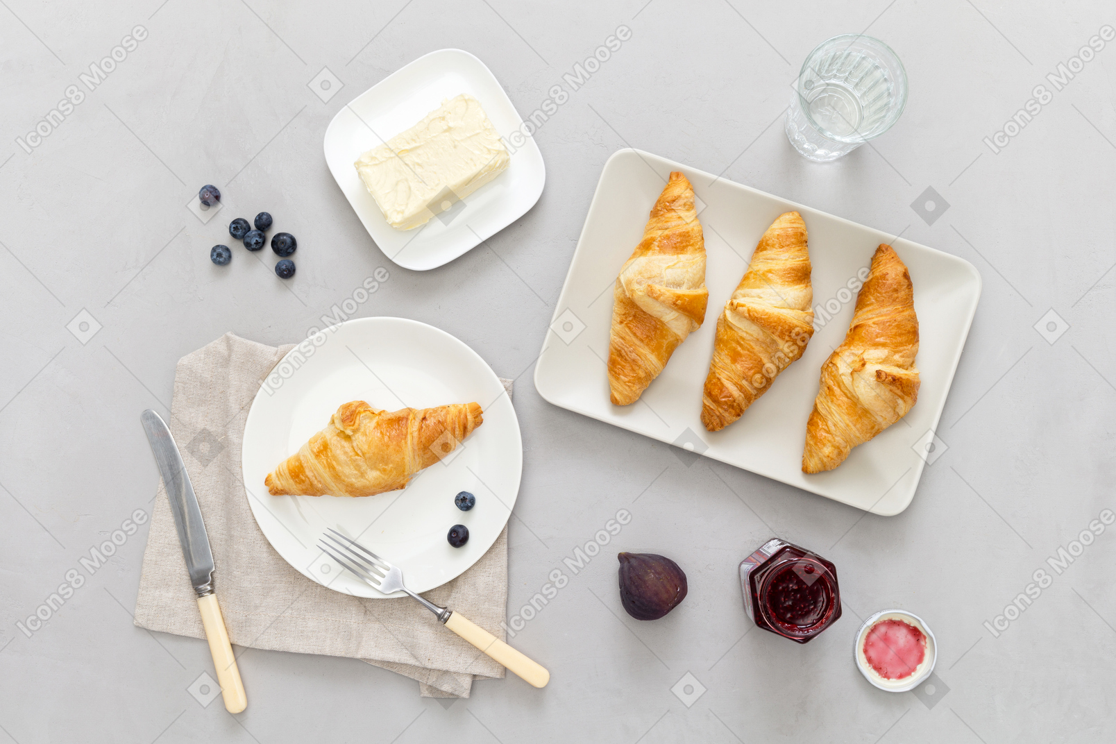 Some croissants, butter and jam