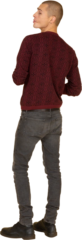 Back view of a bossy young man dressed in red pullover and holding hands together