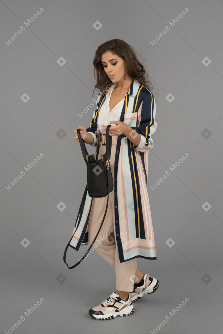 Attractive female walking with a handbag
