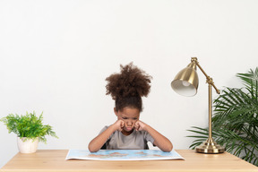 Good looking cute girl with books at the table