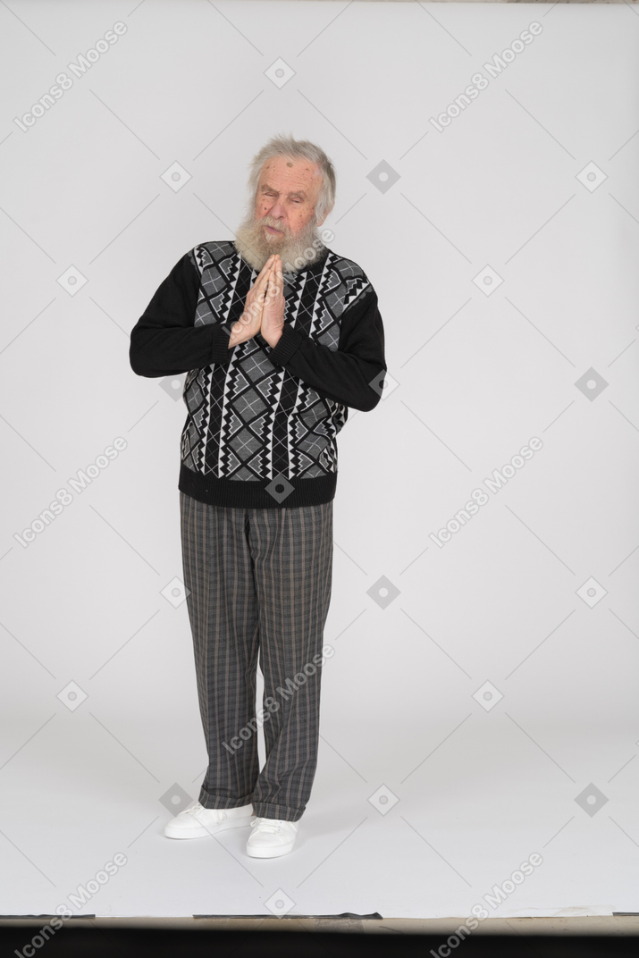 Old man standing with his hands folded