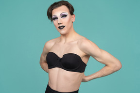 Drag queen putting on black bra