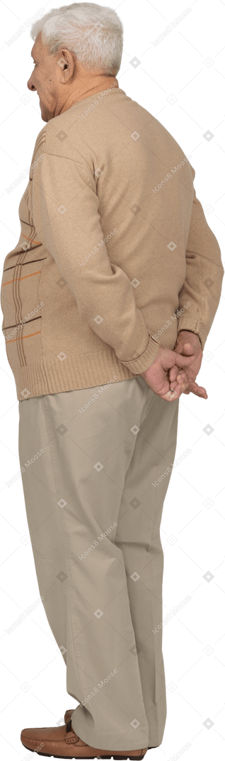 Vista posteriore di un vecchio in abiti casual in piedi con le mani dietro la schiena