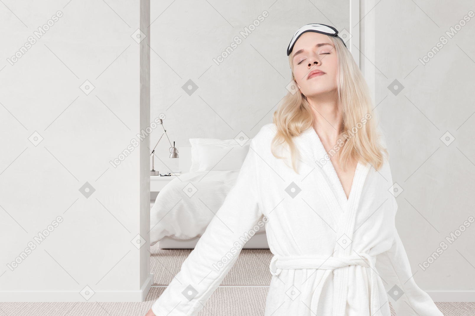 A woman in a white bathrobe standing in front of a mirror