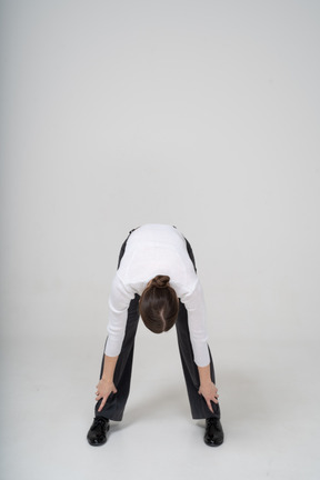 Front view of a young woman bending down