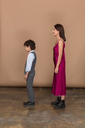 穿红裙子的女人和站在侧面的小男孩