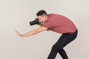 Young guy taking photos with a camera