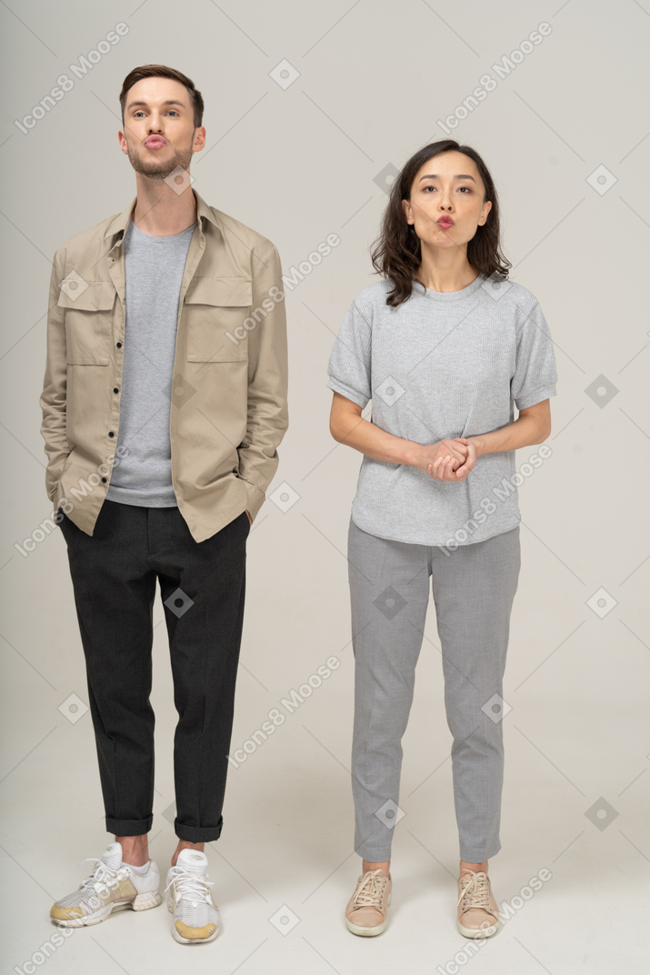 Front view of young couple pouting