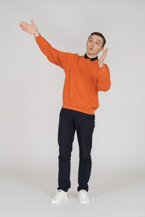 Young man in orange sweatshirt standing