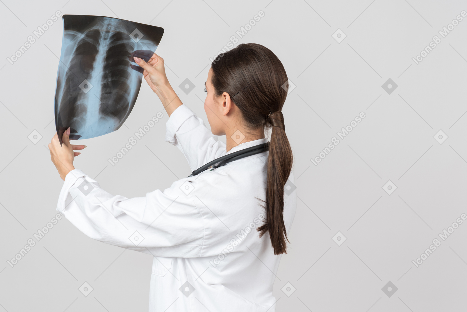 Young female doctor looking attentively on x-ray photograph