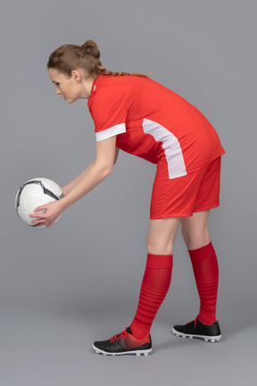 A football player is about to pass the ball