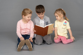 Little boy reading for his friends