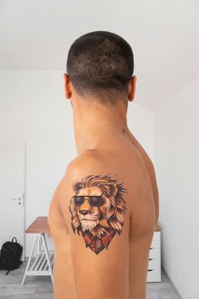 Young man with a lion tattoo
