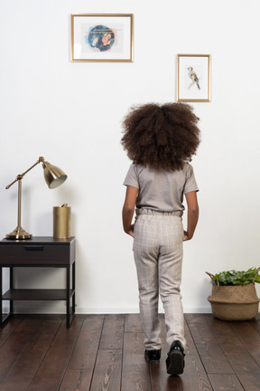 Good looking girl kid posing on the apartment background