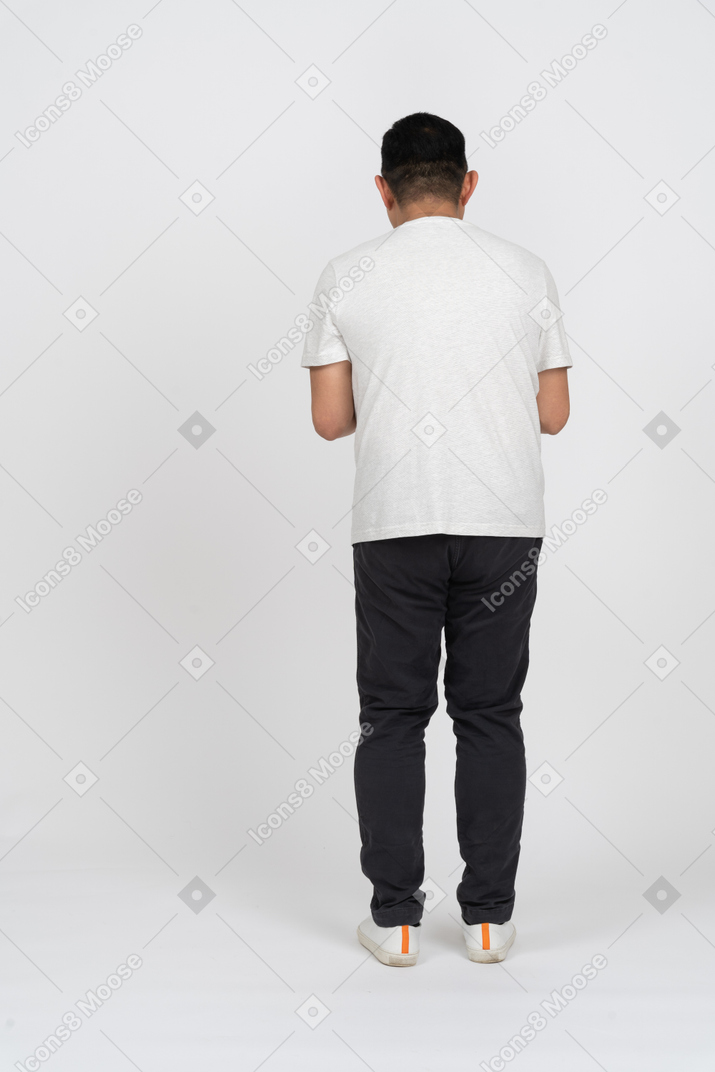 Back view of a man in casual clothes plotting something