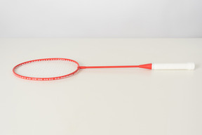 Red tennis racket on a white backgroud