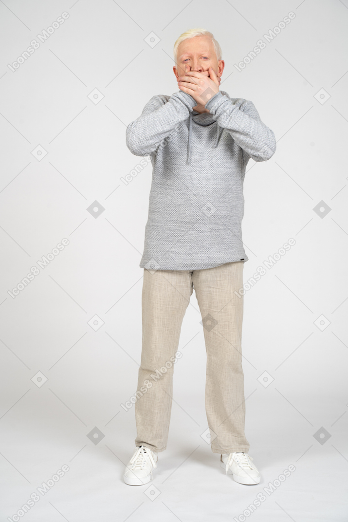 Front view of man covering his mouth with both hands