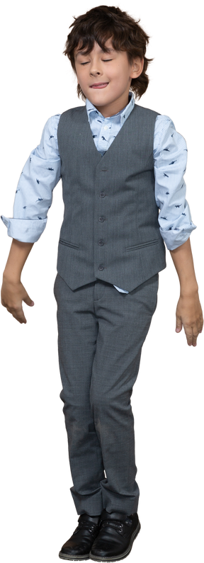 Front view of a boy in grey suit dancing