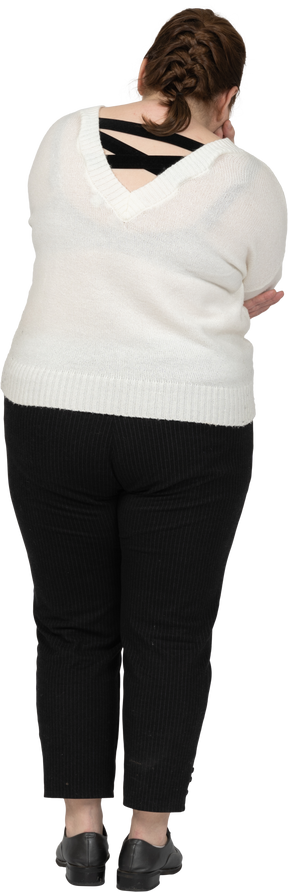 Rear view of a plus size woman in casual clothes