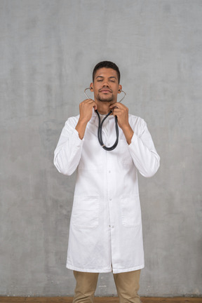 Male doctor using his stethoscope