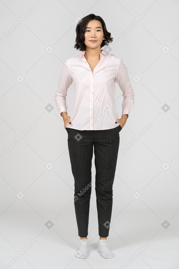 Cheerful office worker posing with hands on hips