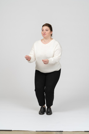 Front view of a plump woman in casual clothes squatting