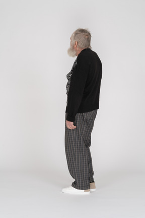 Side view of an elderly man standing and looking away